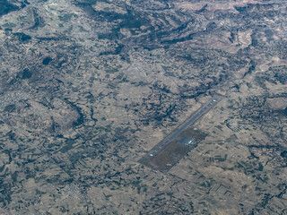 aerial landscape view of Axum Airport (IATA: AXU, ICAO: HAAX) with runway, apron and buildings, located near Axum a city in northern Ethiopia that is a UNESCO World Heritage site