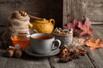 Cozy autumn tea arrangement featuring warm hues, seasonal decor, and wooden table background. MZ 