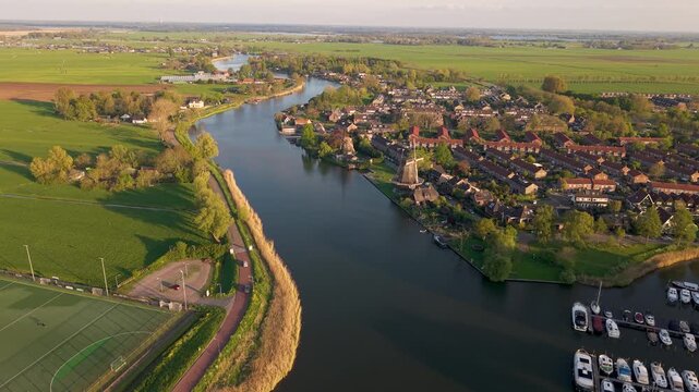 Aerial view of river Vecht and two historical dutch windmills in the city of Weesp