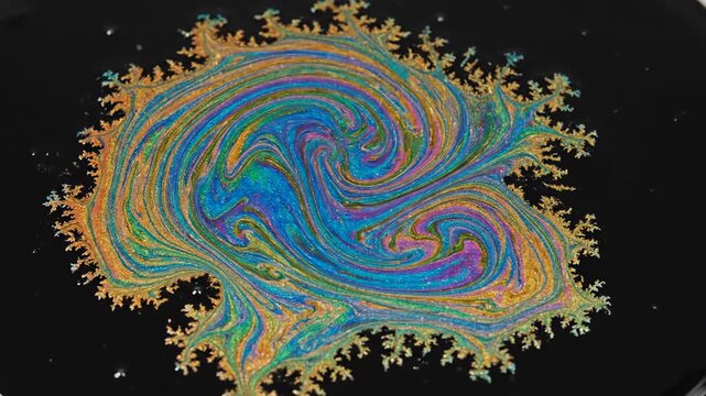 Macro close-up shot of vibrant iridescent oil slick spreading across a black liquid surface in extreme slow motion texture, close-up, concept