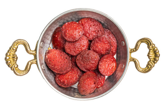 Fried Turkish sucuk (sujuk) slices in a traditional copper pan (sahan). Spicy sausage breakfast dish, top view.