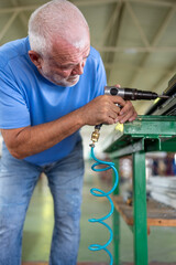 A worker in an aluminum and PVC factory works on profiles.