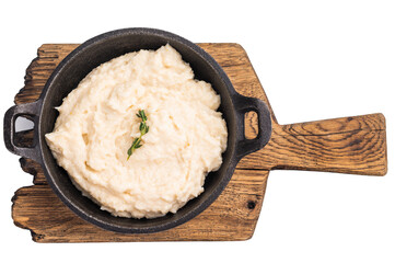 Creamy horseradish sauce in a rustic black cast iron bowl, garnished with a fresh sprig of thyme. Isolated on white background.