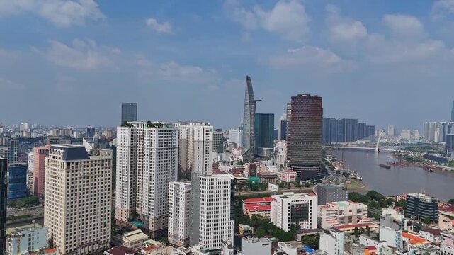Drone shot of Ho Chi Minh City skyline centered on Landmark 81 tower rising above apartment buildings.