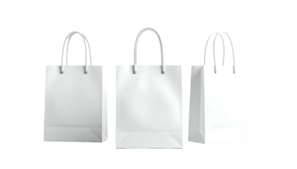 Three bright white paper shopping bags with sturdy handles are arranged against a stark black background