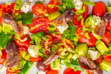 Extreme Close-up of Vibrant Traditional Greek Salad with Feta Cheese, Olives, Cured Sausage, and Fresh Vegetables
