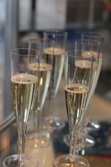 Sparkling wine stock photo. Champagne flutes on dining table. Toast or holiday celebration. 