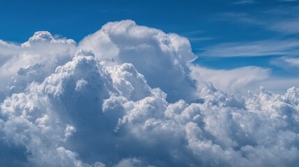 Fluffy clouds fill the sky creating a stunning display on a clear and sunny day.
