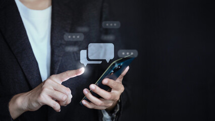 Businesswoman using smartphone with virtual chat bubble icons. Communication concept.