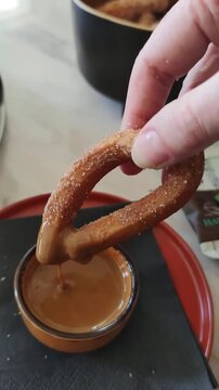 Close-up of Churro Dipped in Thick Caramel or Dulce de Leche Sauce