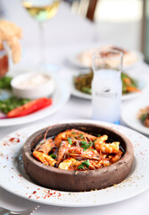 Mediterranean and Turkish meyhane cuisine with seafood, mezes, salads, grilled dishes, fresh fish, appetizers and desserts served in a modern restaurant setting.