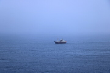 a ship in the fog approaches the Faroe Islands, Denmark