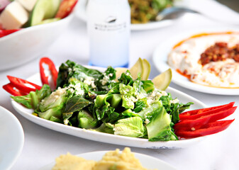 Mediterranean and Turkish meyhane cuisine with seafood, mezes, salads, grilled dishes, fresh fish, appetizers and desserts served in a modern restaurant setting.