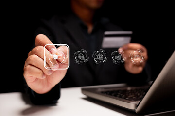 A person interacts with digital payment options on a laptop, showcasing modern online transaction technology in a dark setting.
