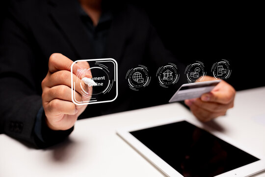 A person using a credit card to make an online payment on a tablet, with digital icons representing different transaction options.