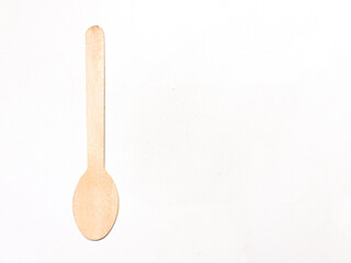 wooden kitchen utensils. A simple disposable wooden spoon placed on a white background