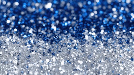 Fototapeta premium Shimmering blue and silver glitter forms a captivating textured surface perfect for crafts.