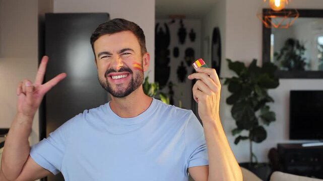 Man painting the Spanish national flag on his face