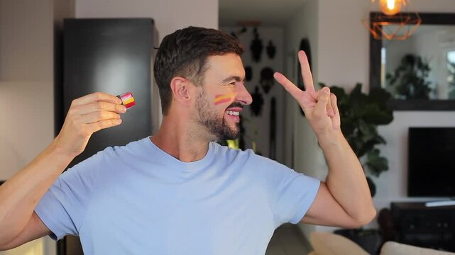 Man painting the Spanish flag on his face 