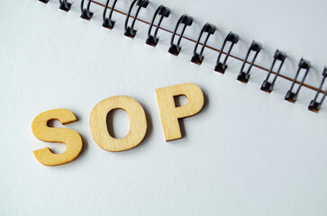 Standard Operating Procedures wooden text on white notepad.