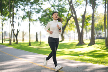 Asian adult woman runs jogs exercise outdoor park path achieve health wellness fitness training...