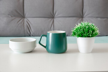 bowl, mug and artificial flower on table, selective focus