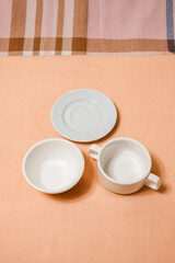 white empty dishes bowls and saucers on table
