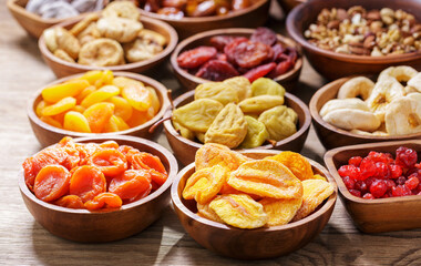 bowls of dried fruits on wooden table
