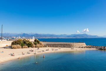 ANTIBES, FRANCE - SEPTEMBER 29, 2025: People on Plage de la Gravette - famous and popular sand beach near the Old Town of Antibes, France.
