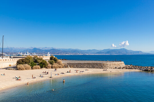 ANTIBES, FRANCE - SEPTEMBER 29, 2025: People on Plage de la Gravette - famous and popular sand beach near the Old Town of Antibes, France.