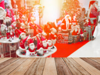 Wooden table top over Christmas ornaments background at department store.