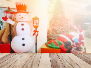 Wooden table top over Christmas ornaments background at department store.