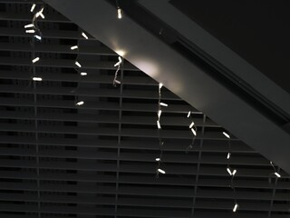 Garlands of white lights on a dark ceiling