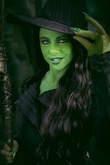 Close up potrait of a pretty girl cosplayer dressed as The Wicked Witch of The West Elphaba Thropp
