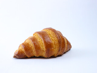 Golden, flaky croissant on a clean white background, showcasing crisp layers and buttery texture, ideal for bakery, breakfast, or food product imagery
