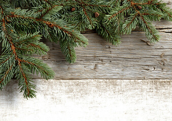 Christmas classic background with empty space for text. Fir cones, pine branches, and red berries on a wooden rural vintage background.