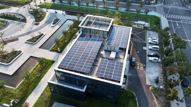 Aerial view of a modern building with solar panels installed on its rooftop in an urban environment