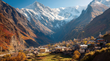 A quaint village led in a valley is surrounded by majestic mountains with snow-capped peaks on a beautiful sunny day, creating a serene alpine landscape.