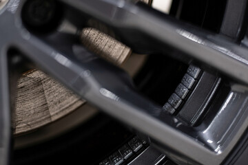 Close-up of adhesive wheel balancing weights installed inside an aluminum alloy rim during professional wheel service, ensuring proper balance, vibration reduction and driving safety.