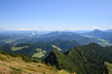 Obraz premium Blick vom Hochfelln in Bayern bei Sonnenschein mit Paraglidern