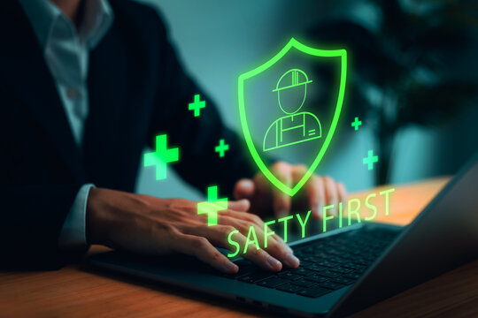 Digital safety-first concept showing worker protection icons glowing above a laptop, representing workplace security, risk management, compliance systems, and modern safety technology solutions.