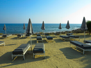 Beautiful landskape, palm trees and sun loungers at luxury resort