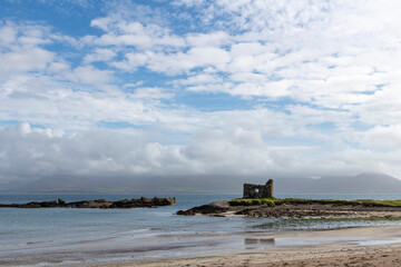 16th century Ballinskelligs Castle near Ballinskelligs, Kerry, Ireland constructed by the MacCarthy Mórs  to protect the bay from pirates against a white clouded blue sky © Sonja