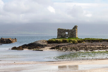 16th century Ballinskelligs Castle near Ballinskelligs, Kerry, Ireland constructed by the MacCarthy Mórs  to protect the bay from pirates against a white clouded blue sky © Sonja