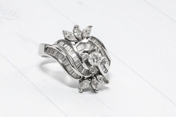 A stunning large white gold ring with natural round, marquise, and trapezoid diamonds.