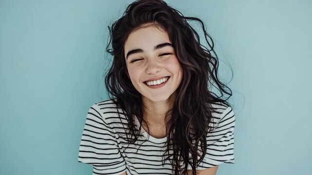 A smiling woman with long dark hair posing for the camera