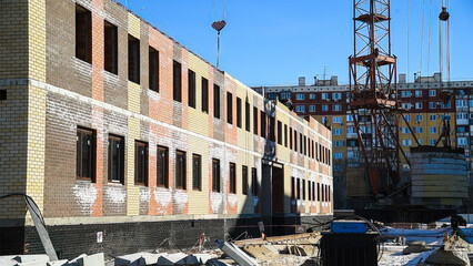 Construction site of an apartment building in winter.