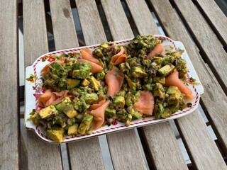 Salad with smoked salmon, avocado, and green leaves. Ideal healthy lunch or dinner concept