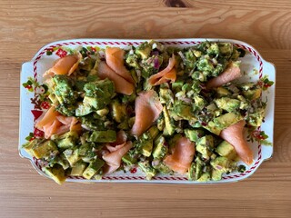 Salad with smoked salmon, avocado, and green leaves. Ideal healthy lunch or dinner concept