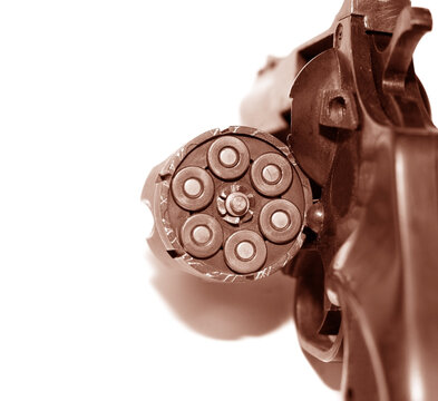 Loaded revolver pistol with cartridges isolated on white background close-up